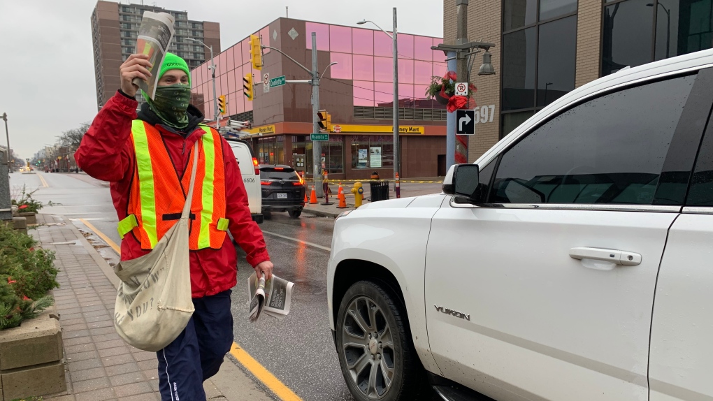 Windsor Goodfellows volunteer Lucas Lalonde collecting for annual paper drive in downtown Windsor, Ont., on Thursday, Nov. 25, 2021. (Chris Campbell / CTV Windsor) 