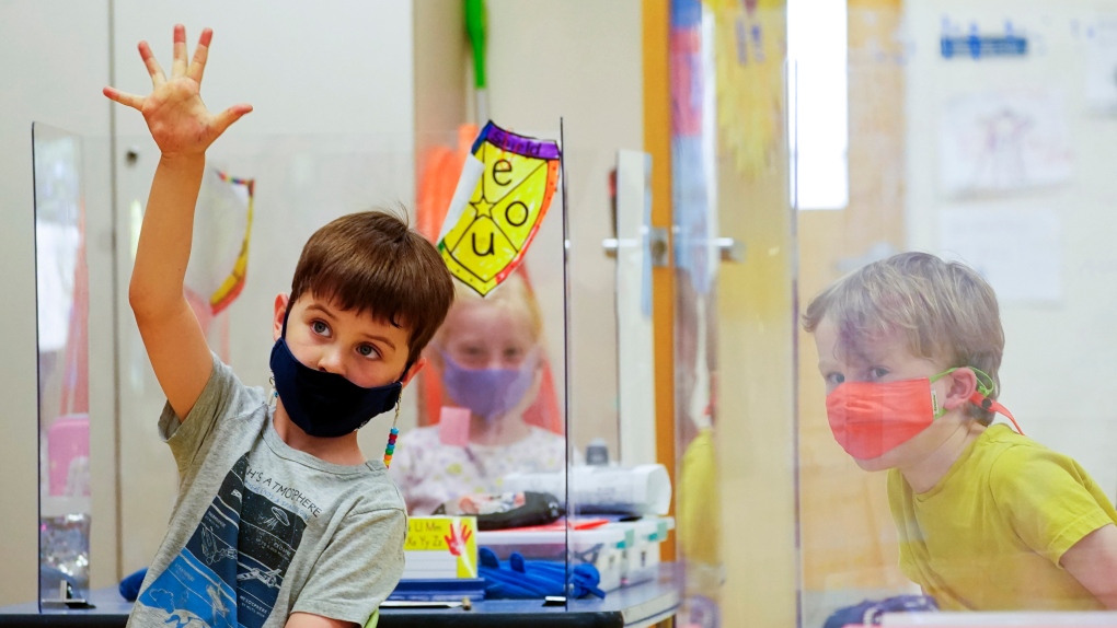 In this May 18, 2021 photo, kindergarten students wear masks and are separated by plexiglass during a math lesson at the Milton Elementary School, in Rye, N.Y. (AP Photo/Mary Altaffer, File) 