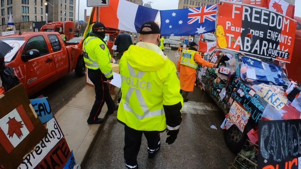 Police hand out new notices to convoy protesters on Thursday, Feb. 17, 2022. (Graham Richardson/CTV News Ottawa)