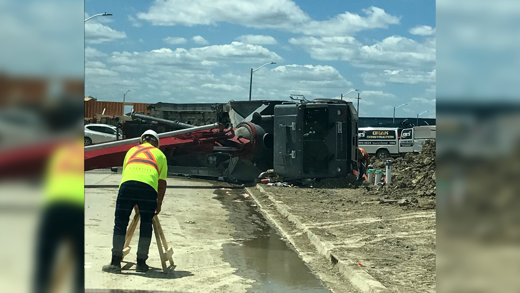 A cement pump truck fell on its side at a construction site near County Road 8 and Highway 3 in Essex, Ont. on Monday, June 27, 2022. (Source: Viewer submitted photo)
