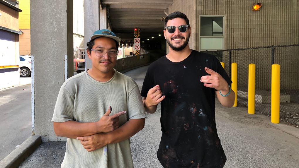 Mural artists Derkz and Moises ‘Luvs’ Frank are working on two new pieces for Art Alley in Windsor, Ont. on Thursday, Aug. 11, 2022. (Gary Archibald/CTV News Windsor) 