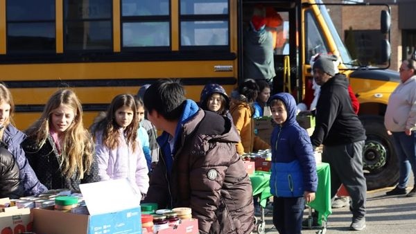 Students load donations onto the 'Santa School Bus' delivering to charities in Windsor-Essex. (Source: Our Lady of Mount Carmel Catholic Elementary School/Facebook)