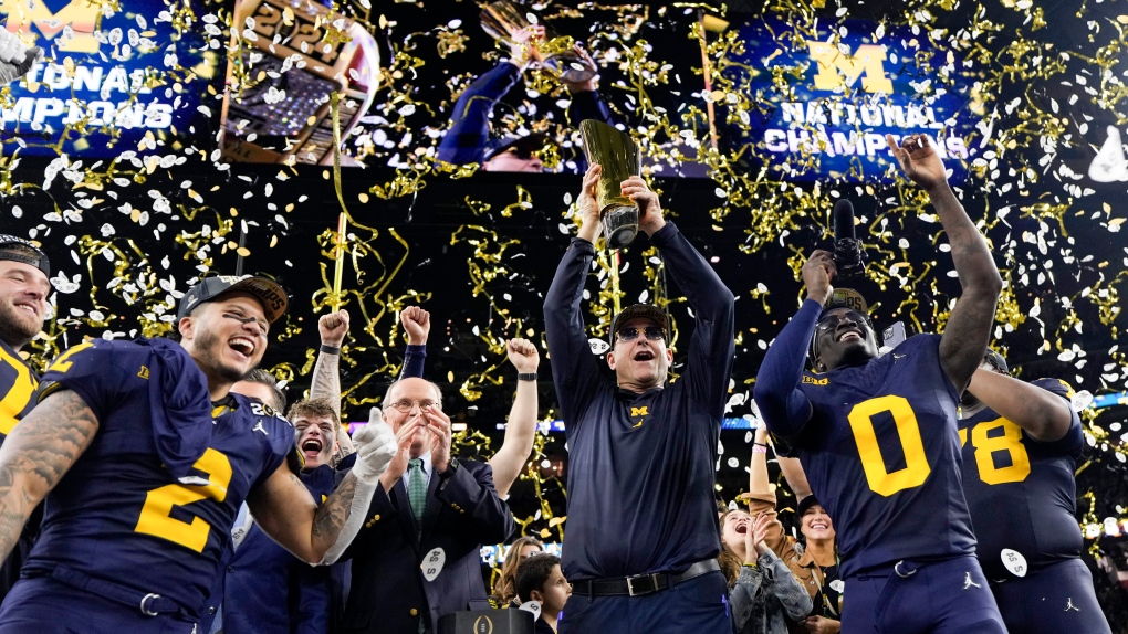 Michigan head coach Jim Harbaugh celebrates with the trophy after their win against Washington in the national championship NCAA College Football Playoff game Monday, Jan. 8, 2024, in Houston. (AP Photo/David J. Phillip)